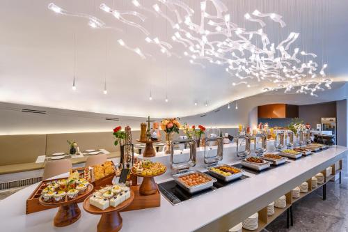 a buffet line with many different types of food at Mercure Huangshan East Gate in Huangshan