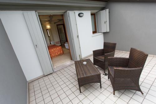 a balcony with a table and chairs and a bedroom at Sweet Home in Treviso