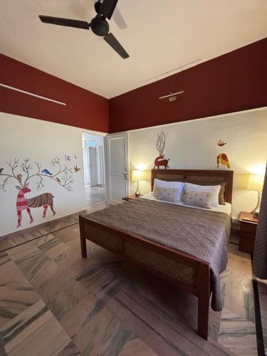 a bedroom with a bed and a ceiling fan at Hans BnB Charming stay amidst nature in Bīr