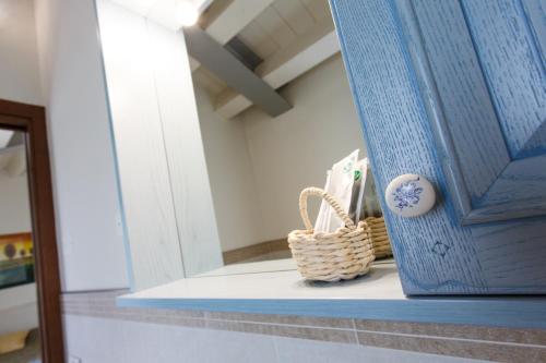 a blue door with two baskets on a shelf at Sweet Home in Treviso