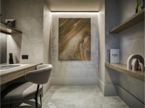 a bathroom with a sink and a counter with a chair at Pullman Melbourne On the Park in Melbourne