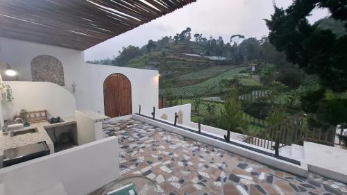 a room with a balcony with a view of a mountain at Hanara Bohemian Villa in Bandung