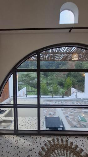 a window in a room with a view of a patio at Hanara Bohemian Villa in Bandung