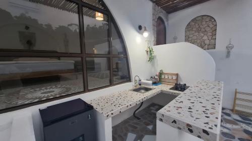 a kitchen with a sink in a room with a window at Hanara Bohemian Villa in Bandung