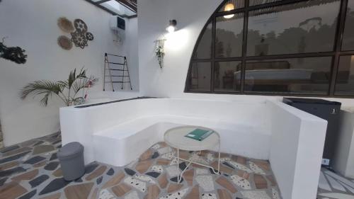a room with a white couch and a stool at Hanara Bohemian Villa in Bandung