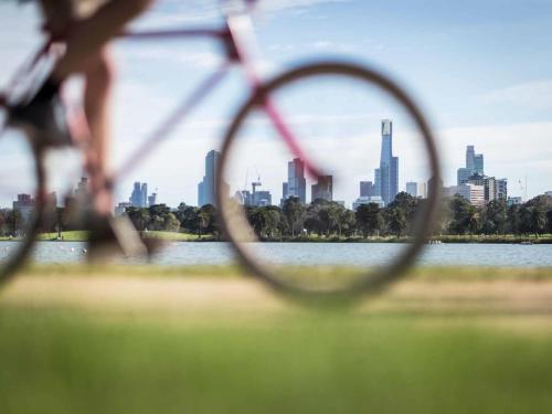 a view of a city skyline through a chain link fence at Pullman Melbourne On the Park in Melbourne