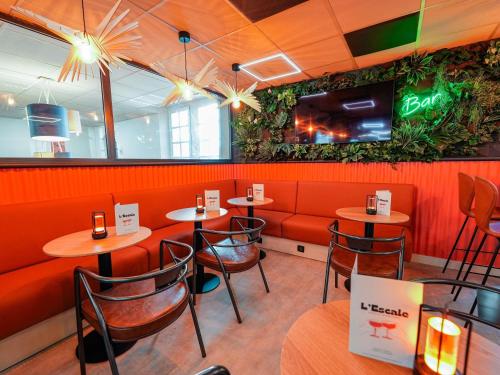 a restaurant with tables and chairs and a bar at ibis budget Marseille Vieux Port in Marseille
