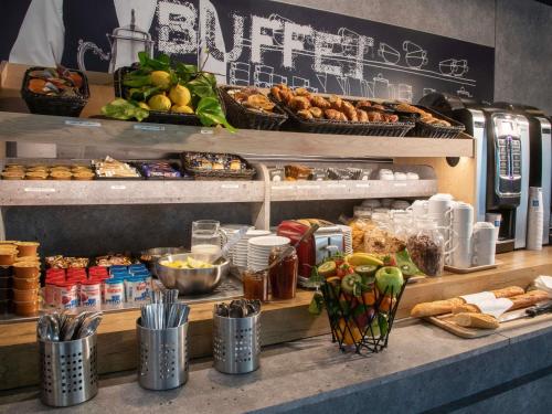 a buffet line with food and other food items at ibis budget Menton Bord de Mer in Menton