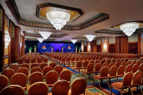 a large room with rows of chairs and a stage at Cairo Marriott Hotel & Omar Khayyam Casino in Cairo