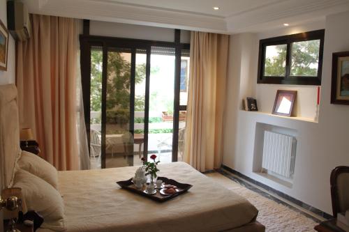 a room with a bed with a tray with flowers on it at Villa Sidi Bou Said in Sidi Bou Saïd