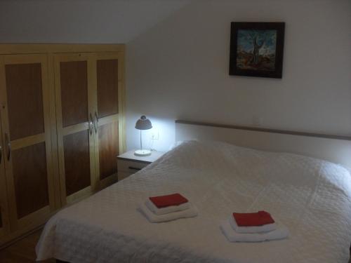 a bedroom with a bed with two towels on it at Apartment Bogoje in Kučište