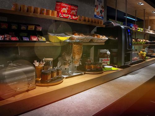a counter in a restaurant with a counter at Ibis Budget Le Havre Les Docks in Le Havre