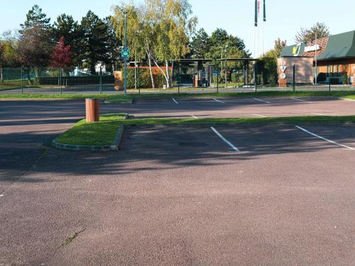 an empty parking lot with a basketball court at ibis budget Caen Porte de Bretagne in Bretteville-sur-Odon
