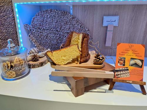 a table with a piece of bread on a cutting board at ibis Budget Le Treport Mers Les Bains in Mers-les-Bains