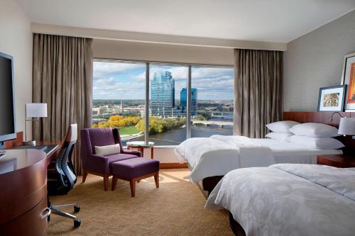 a hotel room with two beds and a large window at JW Marriott Grand Rapids in Grand Rapids