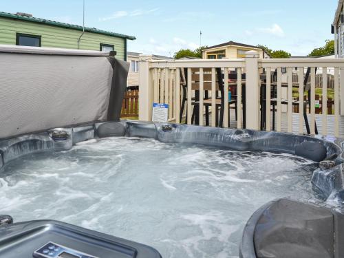 a jacuzzi tub with water in a backyard at Sheldons Place in Patrington