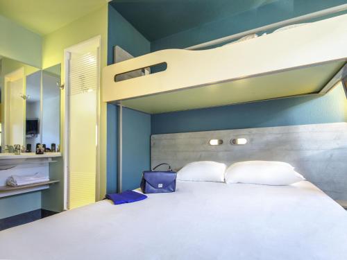 a bedroom with a bunk bed with white pillows at ibis budget Marseille L'Estaque in Marseille