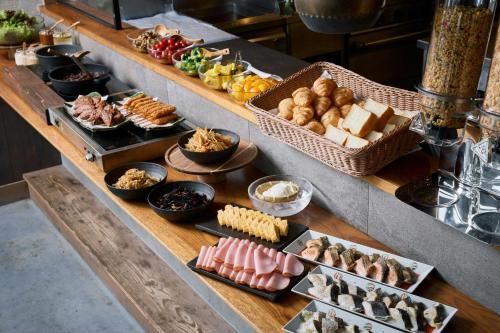 a buffet with different types of food on a table at Four Points Flex by Sheraton Nagoya Station in Nagoya