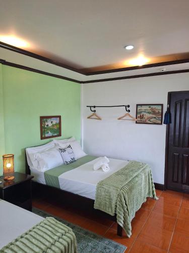 a bedroom with two beds and a table with a lamp at DaRosa Del Mar in Santa Monica