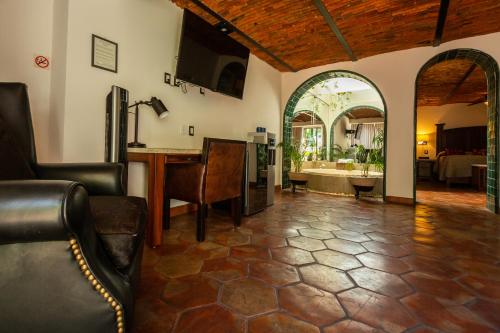a living room with a table and a room with a bathroom at Quinta Don Jose Boutique Hotel in Guadalajara