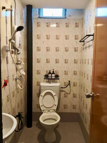 a bathroom with a toilet and a sink at Andiana Hotel & Lodge - Kota Bharu City Centre in Kota Bharu