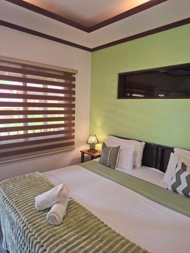 a bedroom with a large bed and a window at DaRosa Del Mar in Santa Monica