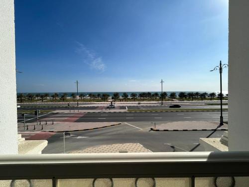 a view of a parking lot from a window at East Coast Vacation Homes in Kalbā