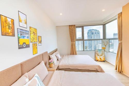 a bedroom with two beds and a window at The Song Boutique Aparment - Căn hộ Anh Kiet Home in Vung Tau