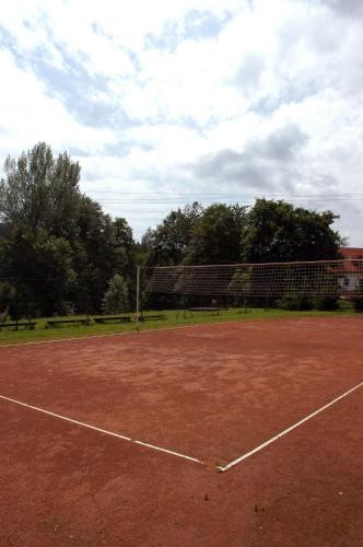 a tennis court with a net on top of it at Penzion Bobešova bouda in Železná Ruda