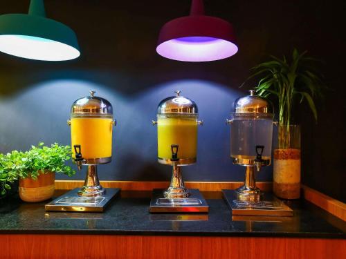 a bar with three juiced drinks on a counter at ibis budget Rio de Janeiro Nova America in Rio de Janeiro
