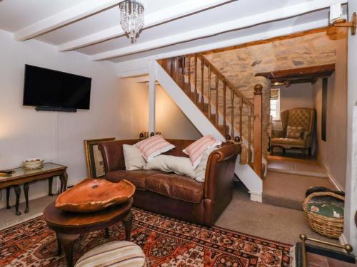 a living room with a couch and a staircase at Dunning, The Mount in York