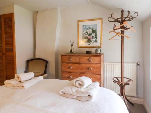 a bedroom with a bed with towels on it at Dunning, The Mount in York