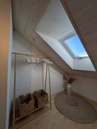 a attic room with a skylight and two baskets at Ferienwohnung Flott in Marktoberdorf