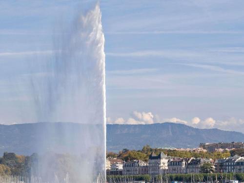 a large water fountain in front of a city at hotelF1 Genève Aéroport Ferney in Ferney-Voltaire