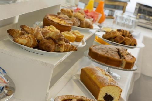 a buffet with several different types of bread and pastries at Toscana Ambassador in Poggibonsi