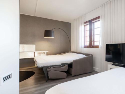 Un ou plusieurs lits dans un hébergement de l'établissement Novotel Suites Perpignan Centre
