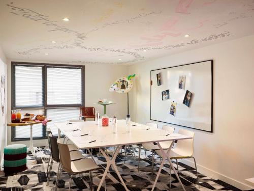 a conference room with a white table and chairs at Mama Shelter Lyon in Lyon