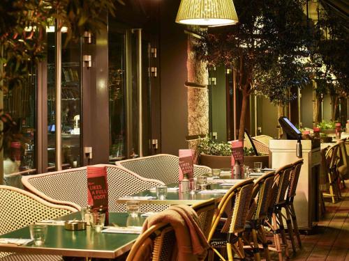 a group of tables and chairs at a restaurant at Mama Shelter Paris East in Paris