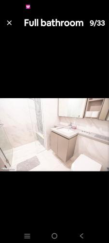 a white bathroom with a sink and a toilet at Eaton kl,2R1B,klcc,500mbps,2-4pax in Kuala Lumpur