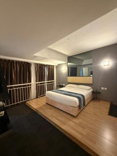 a bedroom with a large bed and a large window at Ayer Keroh Gateway in Ayer Keroh