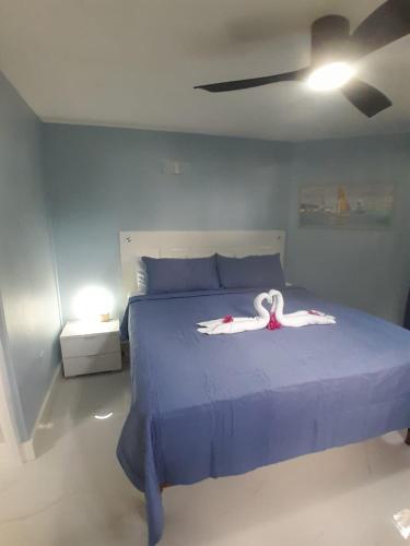 a bedroom with a bed with a swan on it at Beachview 1 Bedroom 4 at Sandcastles in Ocho Rios