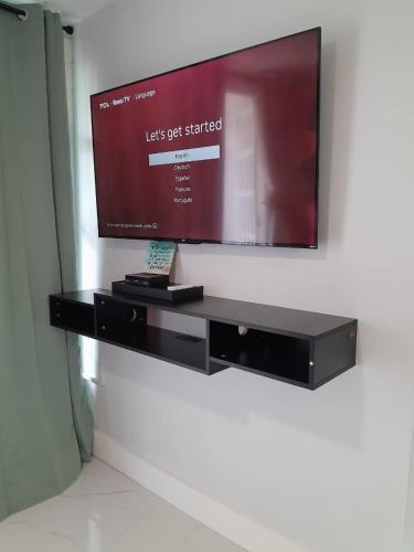 a flat screen tv hanging on a wall at Beachview 1 Bedroom 4 at Sandcastles in Ocho Rios