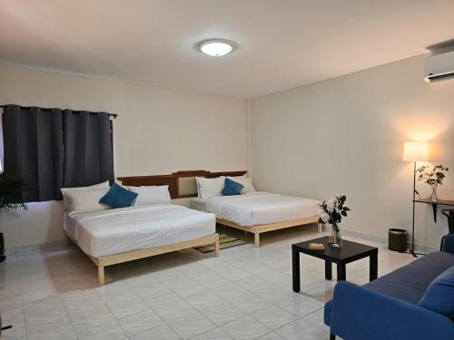 a living room with two beds and a couch at Friends Retreat Phuket in Ban Bo Han