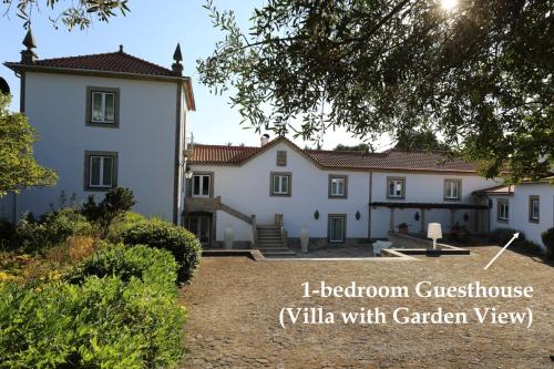 a large white house with the words i bedroom guest house with garden view at Casa dos Macieis - Entire Main House, Entire Guesthouse or Separate Wing of Main House - Camino Santiago direct access & Optional Agritourism in Facha