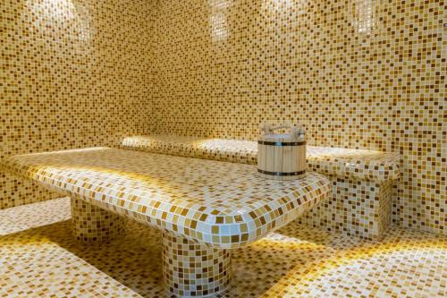 a tiled room with a table in a bathroom at Karvon Plaza Hotel in Samarkand