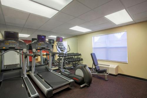 a gym with several tread machines in a room at TownePlace Suites Huntsville in Huntsville