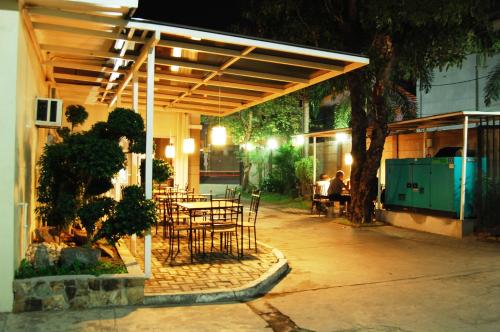 a patio with a table and chairs under awning at Rumi Apartelle Hotel in Angeles