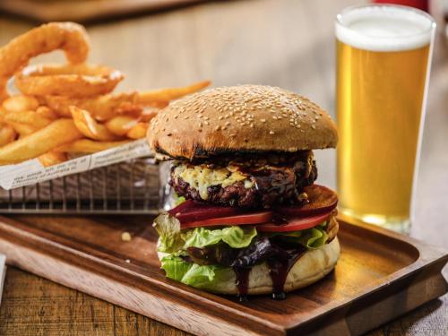 a hamburger and french fries and a glass of beer at Ibis Mackay in Mackay