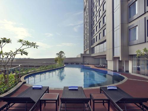 an image of a swimming pool in a building at Mercure Karawang in Karawang