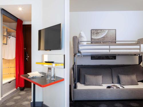 a room with two bunk beds and a table at ibis Styles Paris Mairie de Montreuil in Montreuil